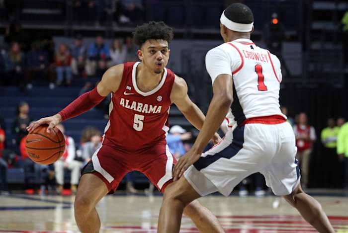 Alabama Crimson Tide guard Jaden Shackelford (5) dribbles as Mississippi Rebels guard Austin Crowley (1) defends at The Pavilion at Ole Miss.